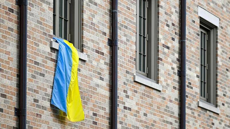 A Ukrainian flag hangs form a dorm room window.