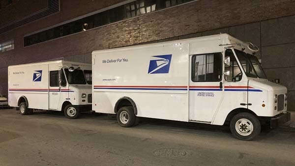 USPS mail trucks parked.