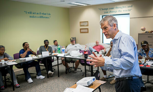 Carl Ackermann teaches a financial literacy class