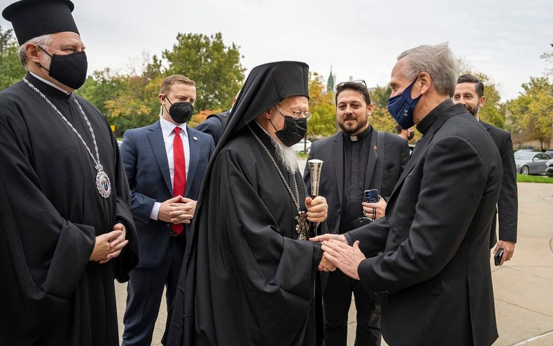 University of Notre Dame president Rev. John I. Jenkins, C.S.C., greets His All-Holiness Bartholomew, Orthodox Archbishop of Constantinople-New Rome and Ecumenical Patriarch upon his arrival at the entrance of the Main Building. All are masked.