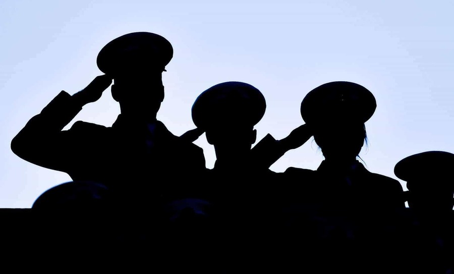 A silhouette of three Naval Academy Midshipmen saluting.