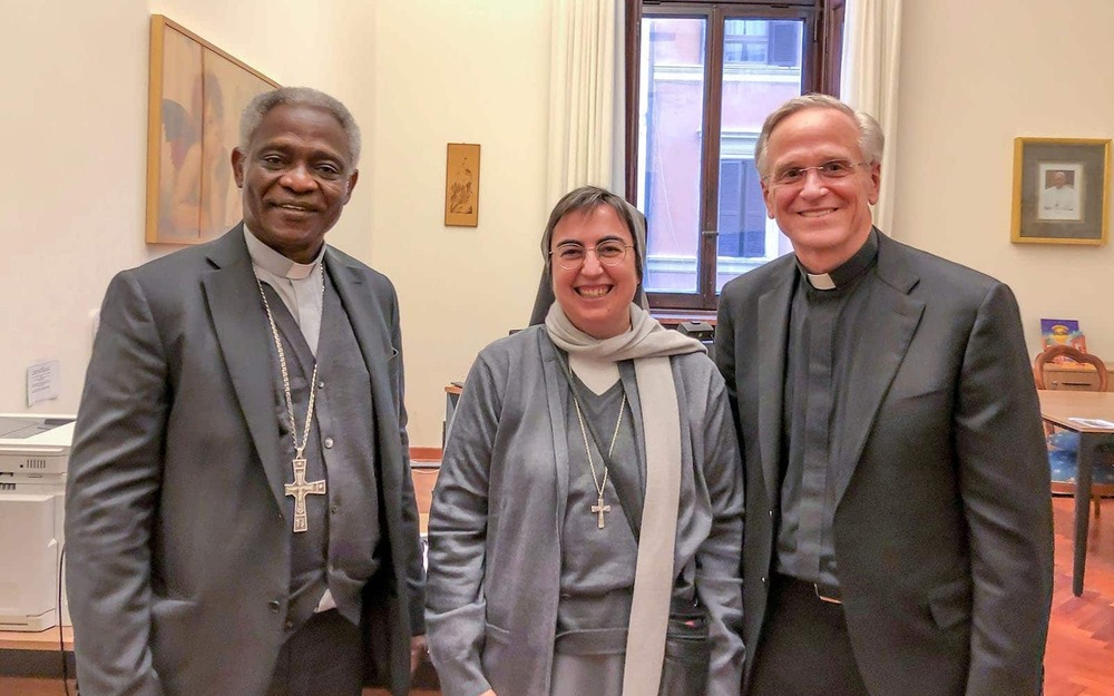 Two priests and a nun pose for a photo.