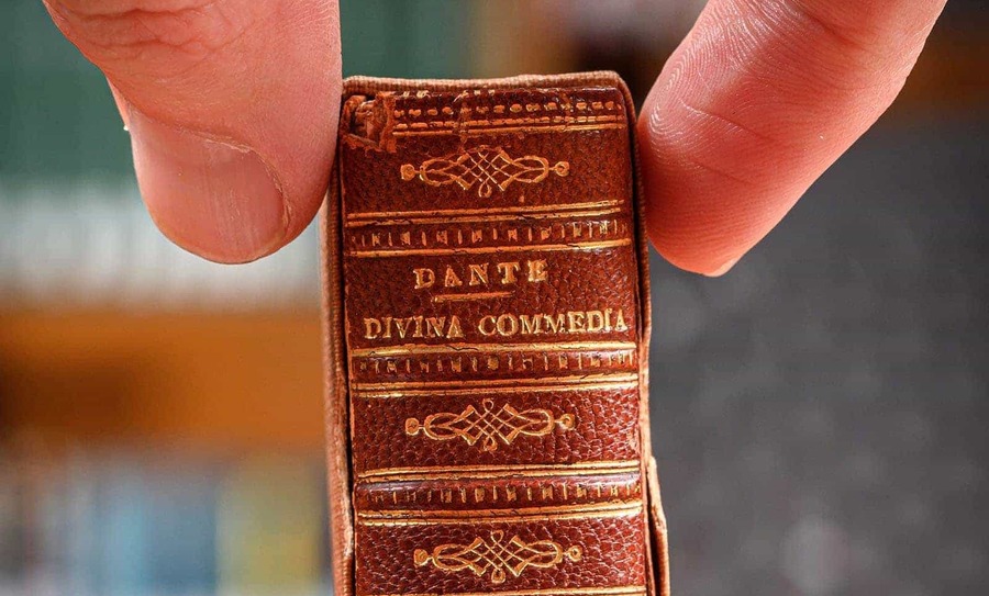 A detail shot of a tiny version of the book, Dante's 'Divine Comedy'.