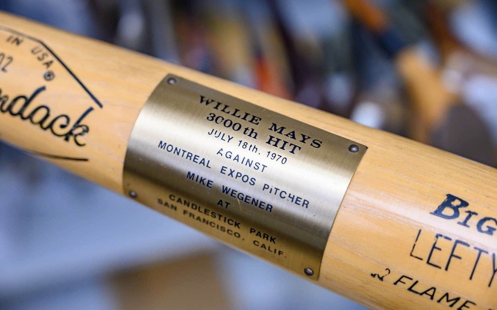 A detail shot of a bat with a plaque that states 