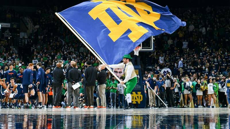 The Notre Dame Leprechaun waves the Monogram flag in front of hundred of fans.