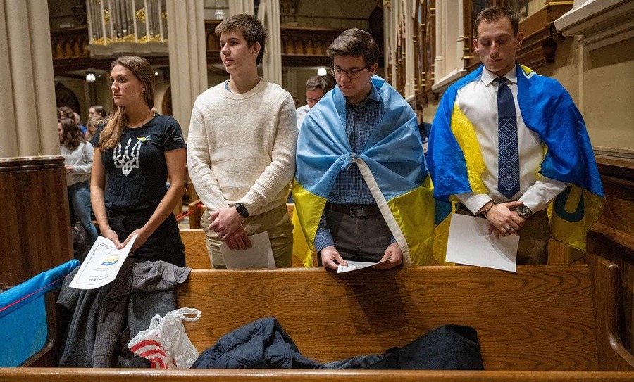 Students draped in the Ukrainian flag during a prayer service in the Basilica.