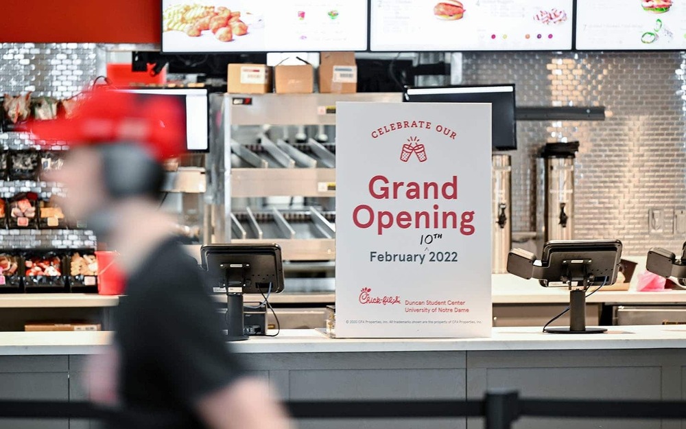 A grand opening sign on the counter of a Chick-fil-A.