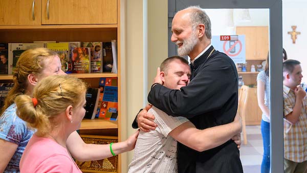 The Right Reverend Borys Gudziak, Archeparch of Philadelphia greets residents of the Emmaus Center at Ukranian Catholic University (UCU).