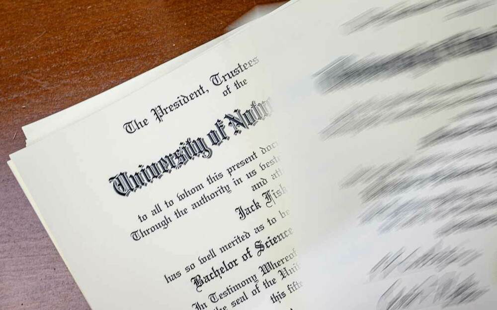 Detail of a diploma lays on a desk.