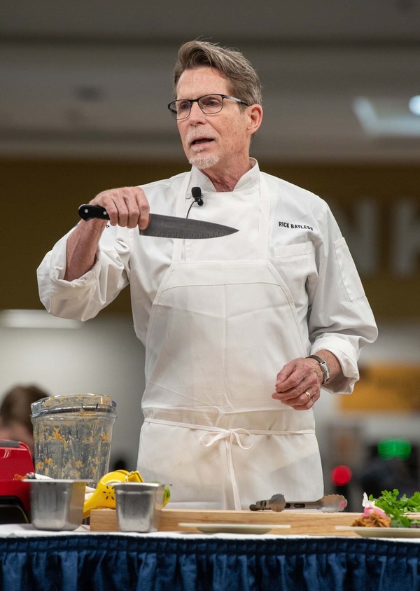 Chef Rick Bayless holding a knife.
