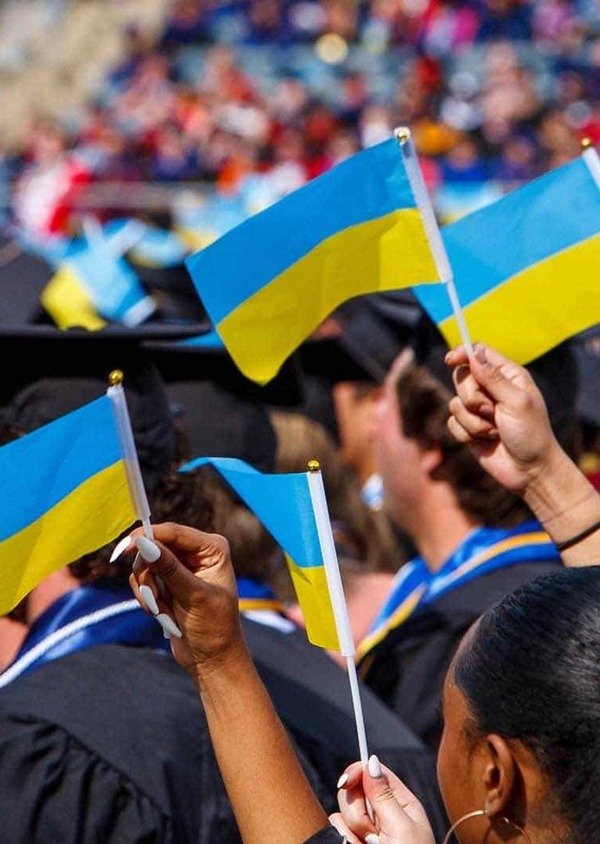 Graduates wave Ukrainian flags.