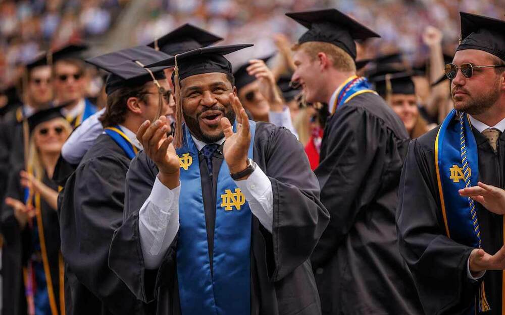 Jerome Bettis claps and celebrates with his classmates at the 2022.