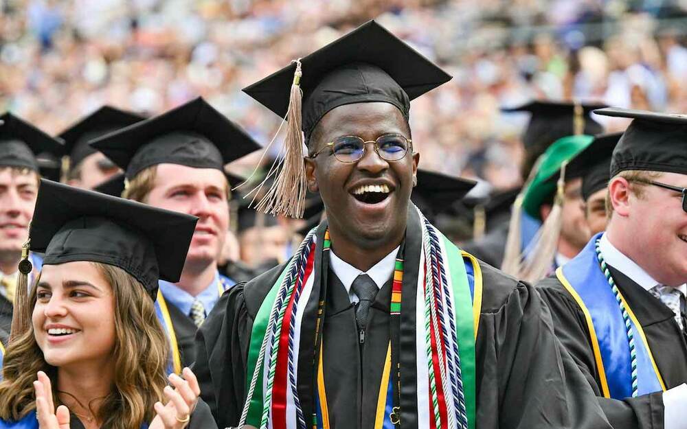 A Black graduate, former Notre Dame Student Body President, Allan Njomo celebrates at the end of the 2022 Commencement ceremony.