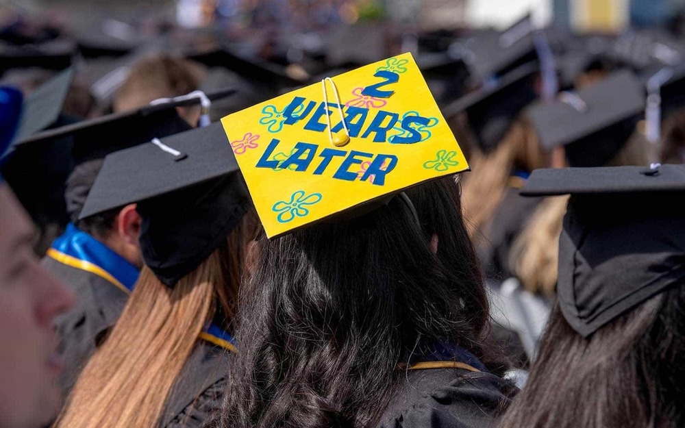 A graduates wears a cap with the message “2 Years Later” at the 2020 Commencement ceremony in Notre Dame Stadium.