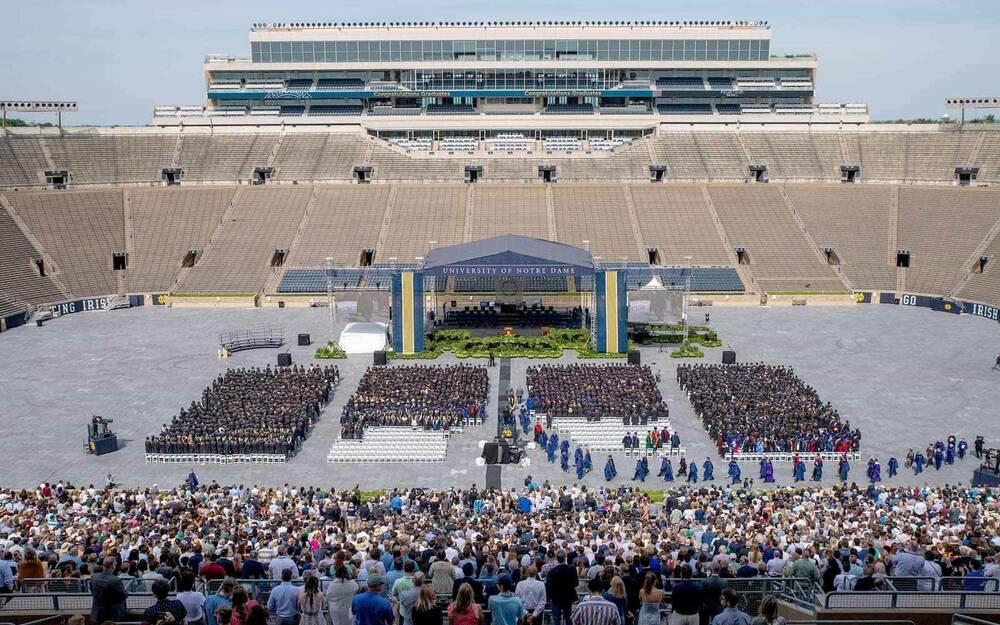 Graduates walk into Notre Dame Stadium before the 2020 Commencement ceremony.