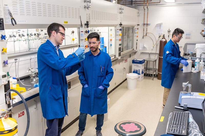 Professor Adam Jaffe works with graduate students in his new lab in Stepan Chemistry.