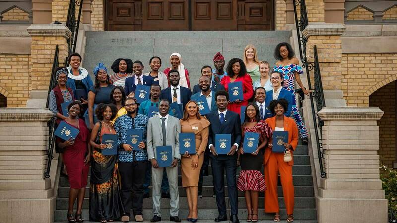 A group from the Mandela Washington Fellowship for Young African Leaders pose for a photo holding diplomas.