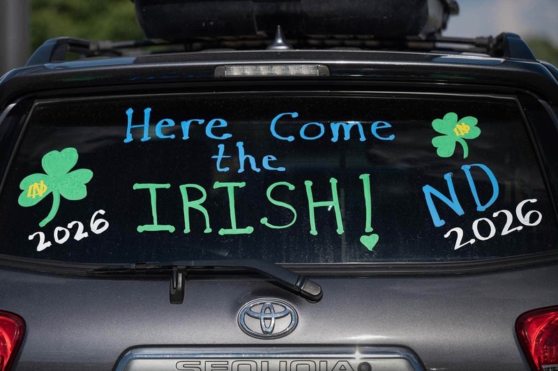 A car decorated with 'Here Come the Irish'.