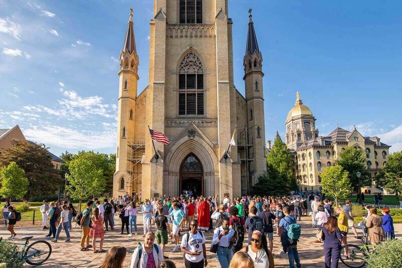 People gather outside around the Basilica of the Sacred Heart.