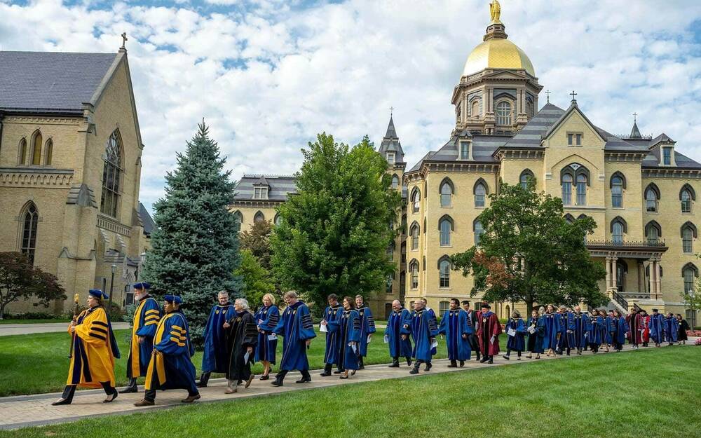 The University Mace leads the academic procession across the Main Quad for the 2022 Opening Mass in the Basilica of the Sacred Heart.