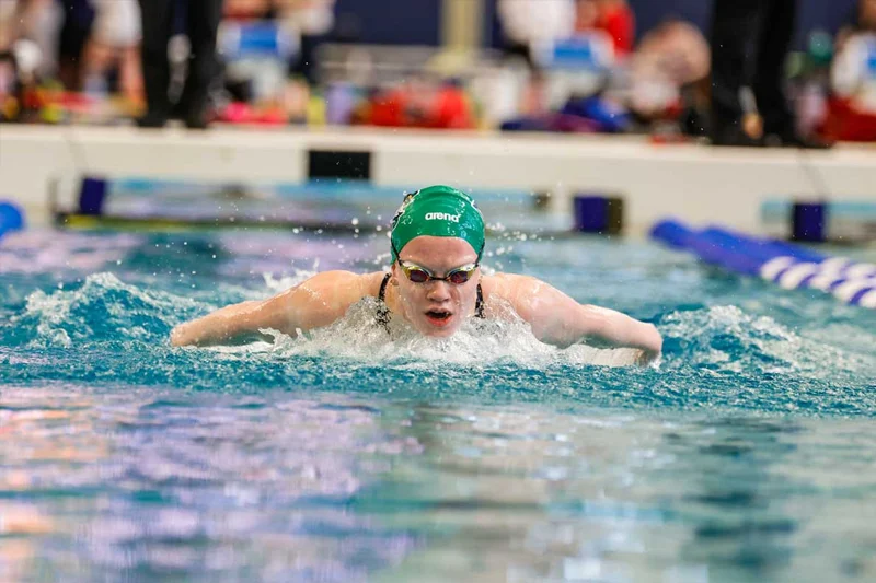 Carli Cronk doing a breast stroke in the pool, her face up out of the water as she takes a breath