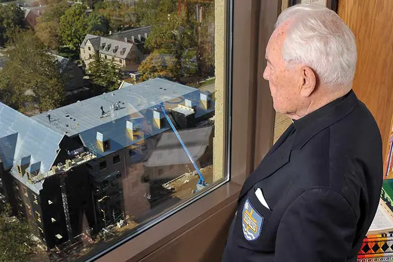 Father Hesburgh looks out the window of his office at Notre Dame campus